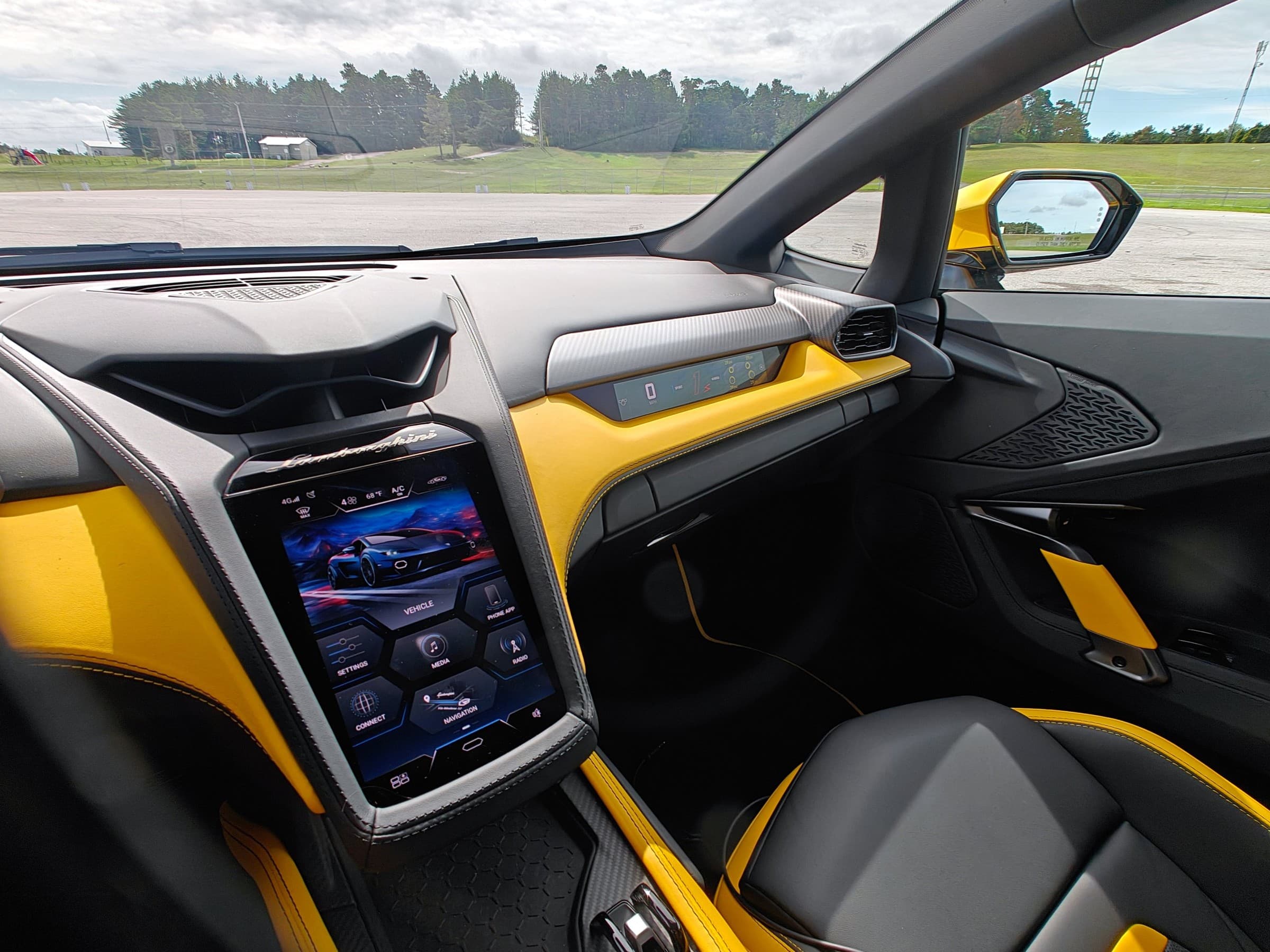 Lamborghini Temerario dashboard with yellow and black leather trim, a portrait-style center touchscreen and a slim passenger-side display.