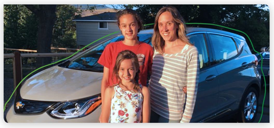 Amber family photo in front of a Chevy Bolt