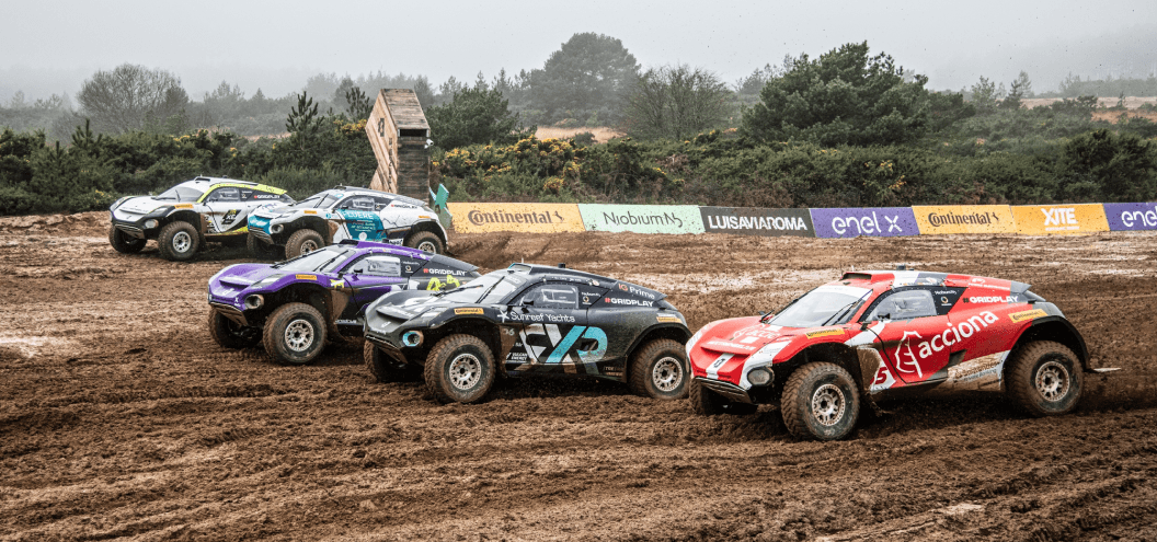 extreme e vehicles racing through mud