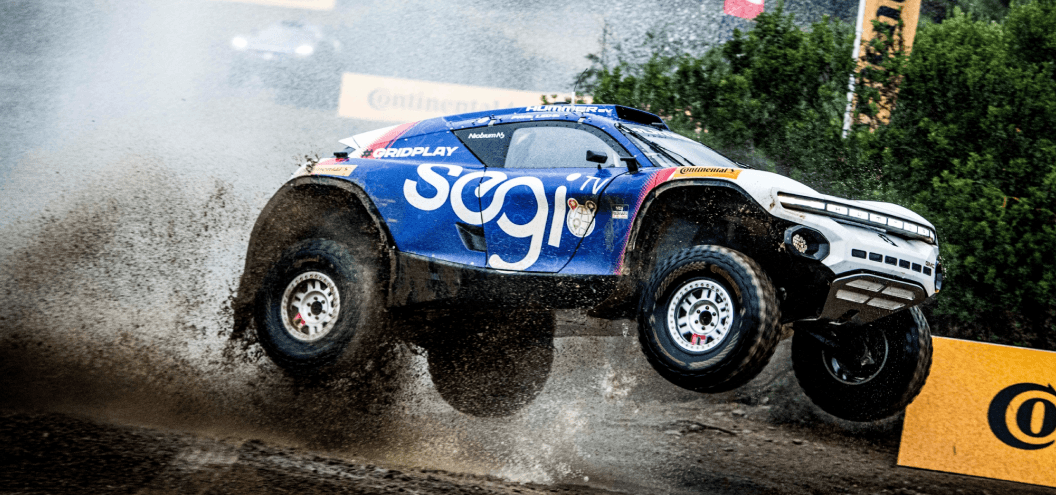 extreme e vehicle jumping through mud