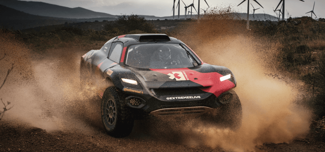 extreme e vehicle racing through dirt