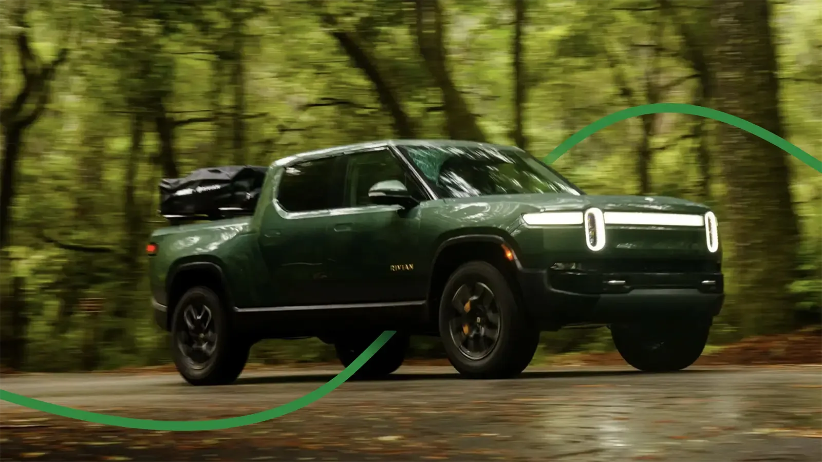 rivian driving on forested road