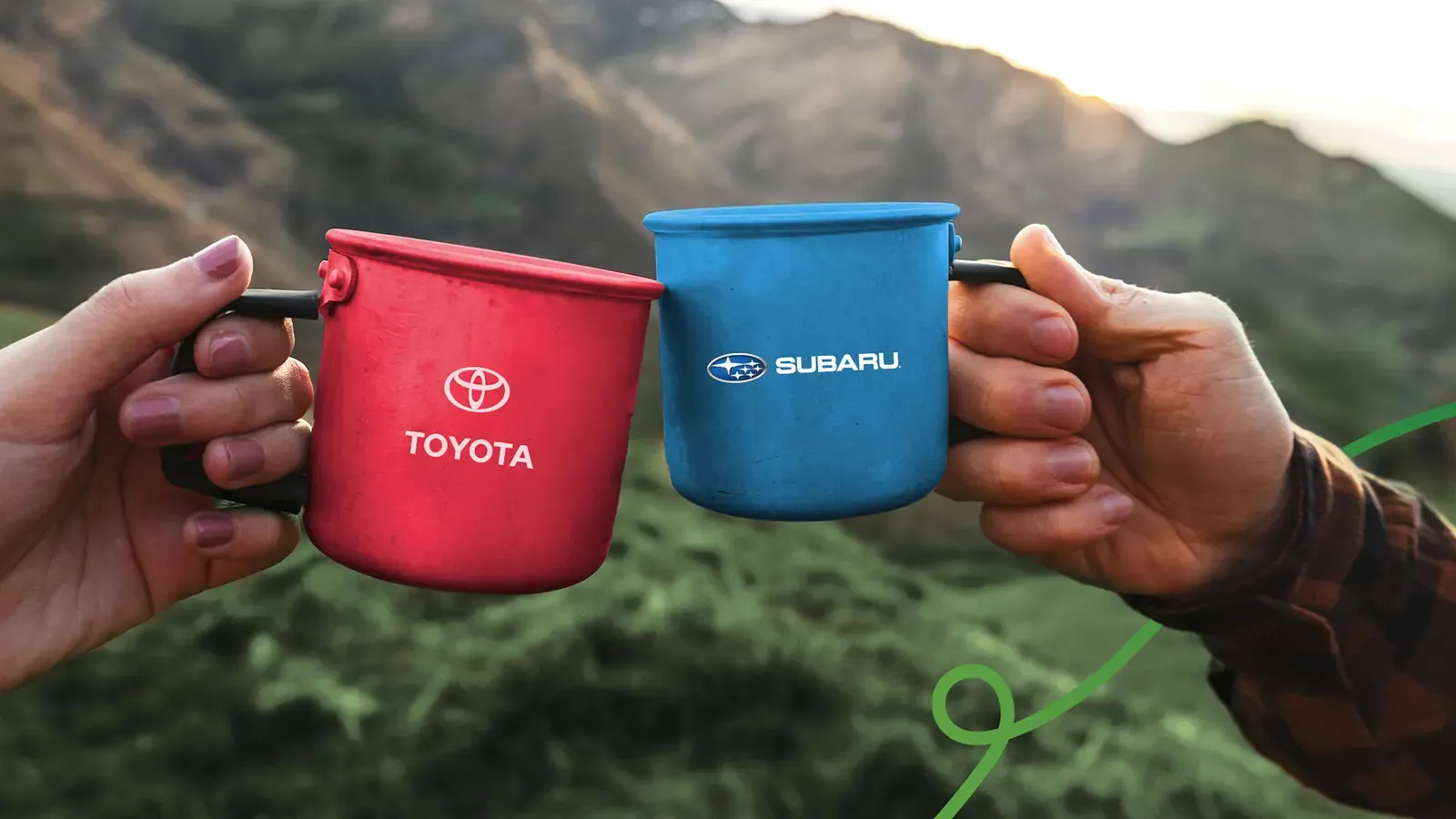 Subaru and Toyota camping mugs in a toast