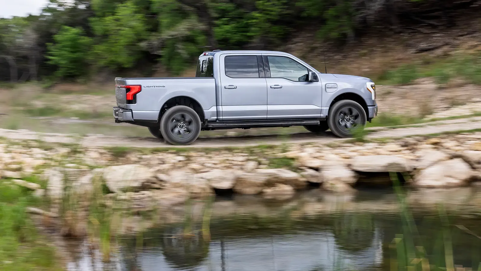 Ford F-150 Lightning driving on rocky terrain