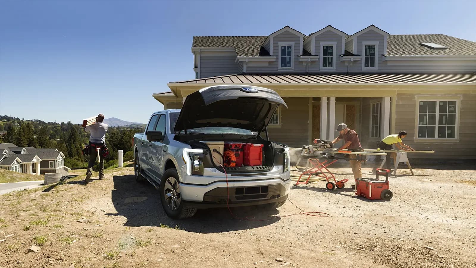 Construction crew cutting lumber behind Ford Lightning truck