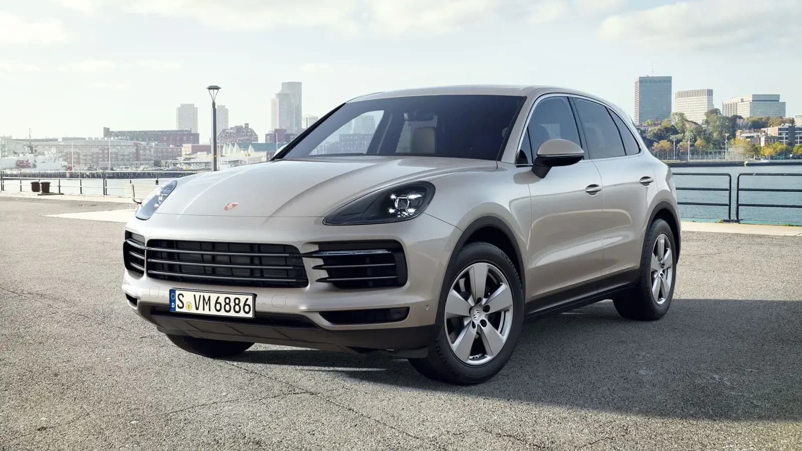 PORSCHE CAYENNE PARKED NEAR A RIVER IN A CITY