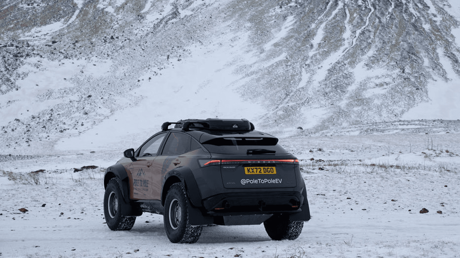 Back view of Nissan Ariya e-4orce in snowy environment. 