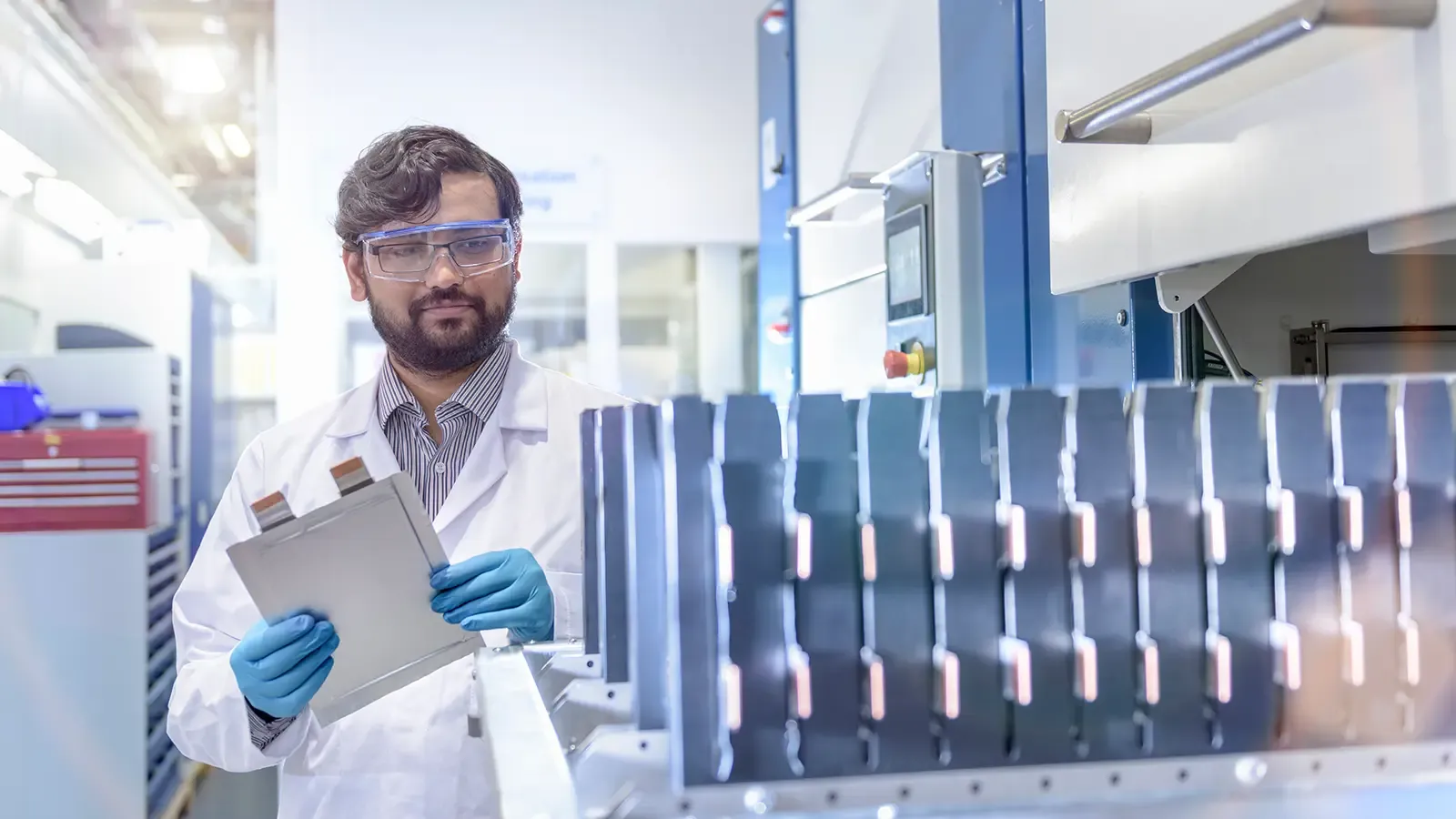Scientists in lab assembling lithium ion batteries.
