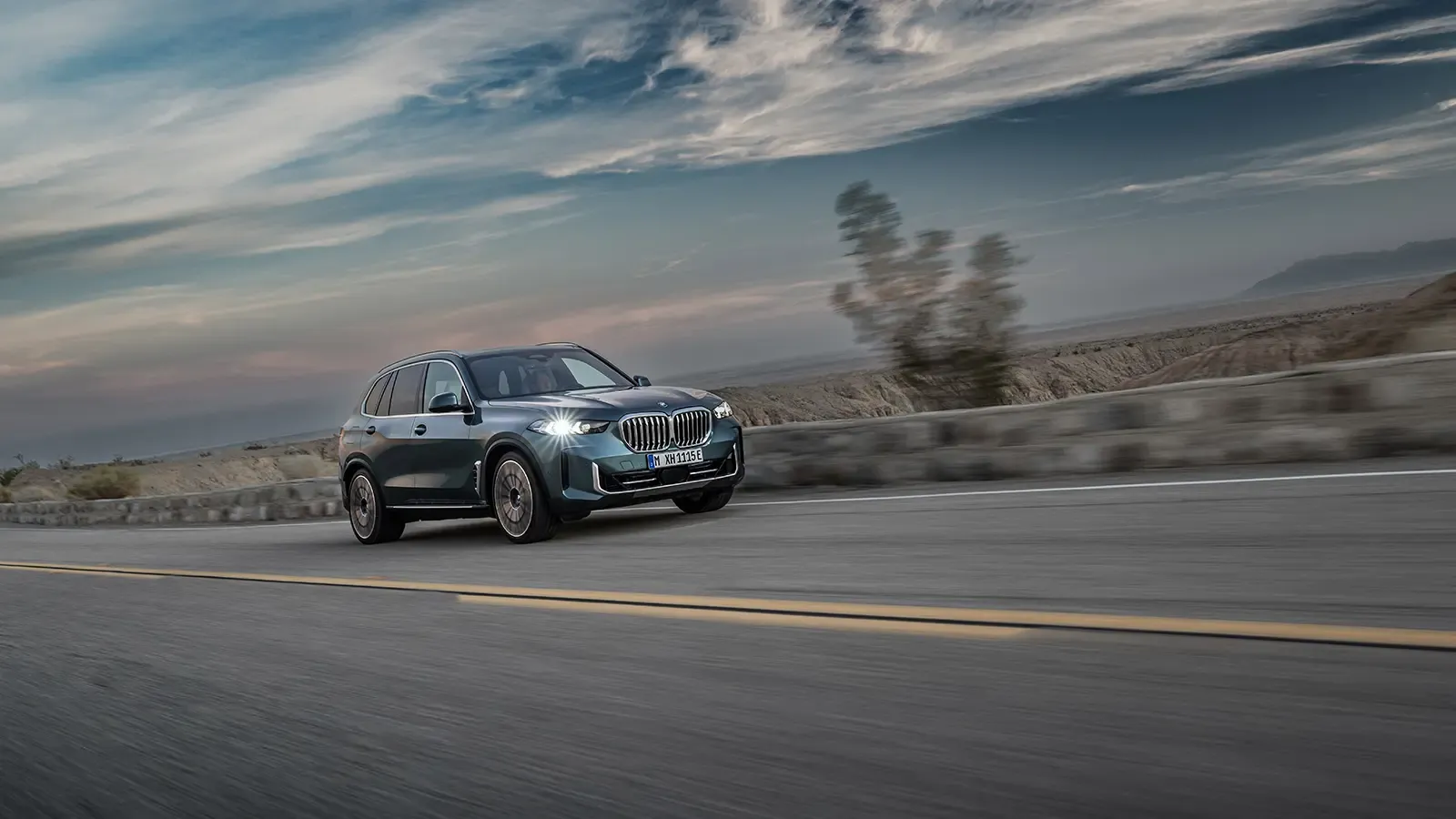 3/4 view of BMW X5 driving in desert
