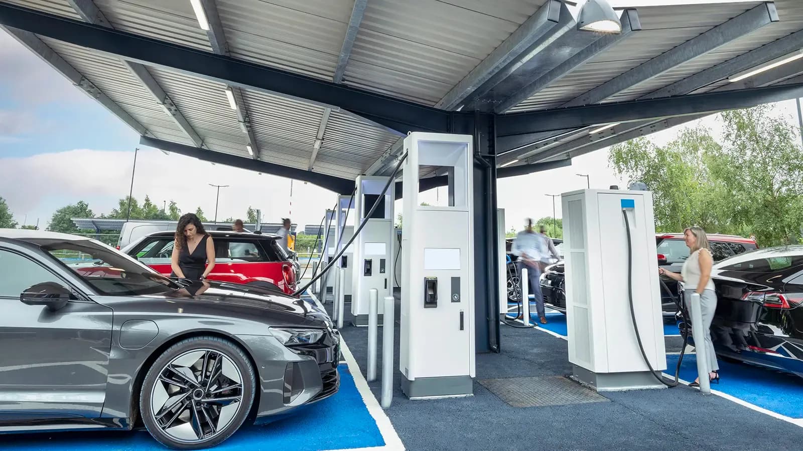 Numerous people at an EV charging station
