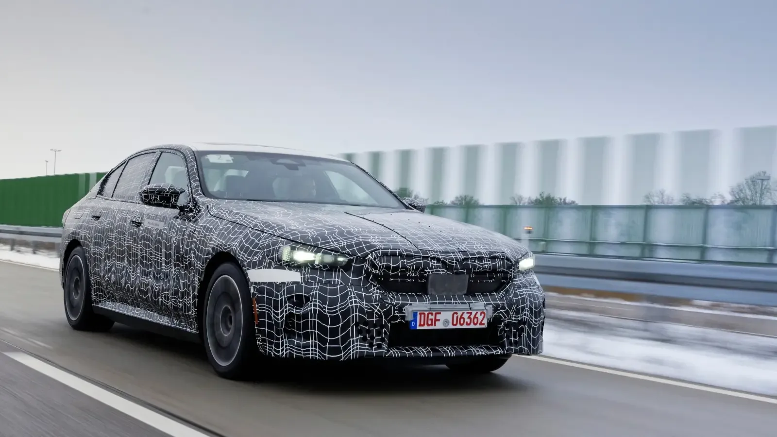 bmw i5 driving on road