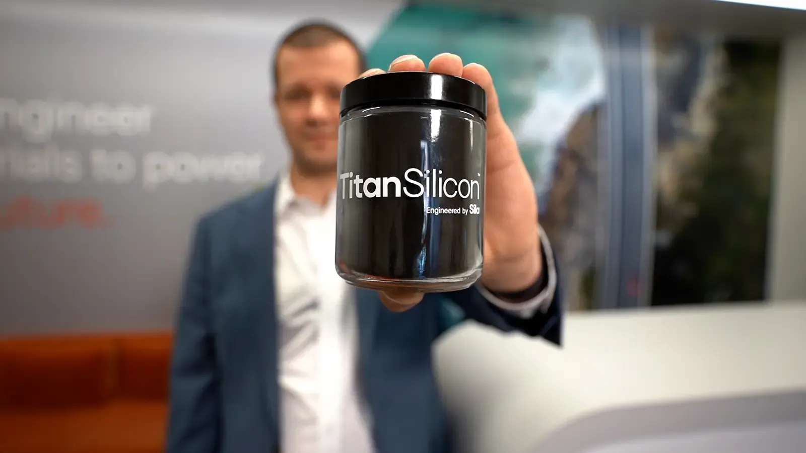 man holding a jar of Titan Silicon