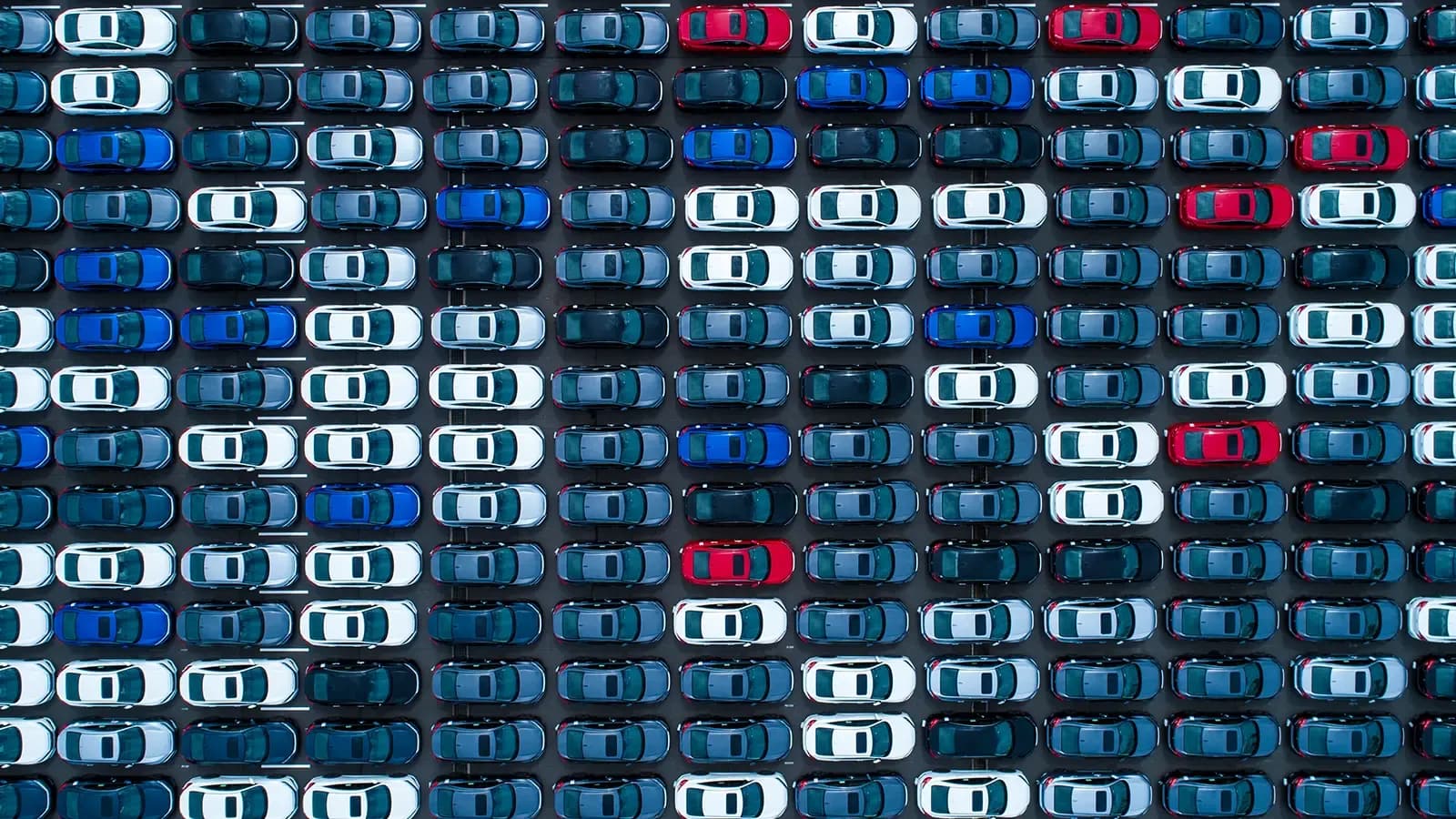 rows of cars in a parking lot 