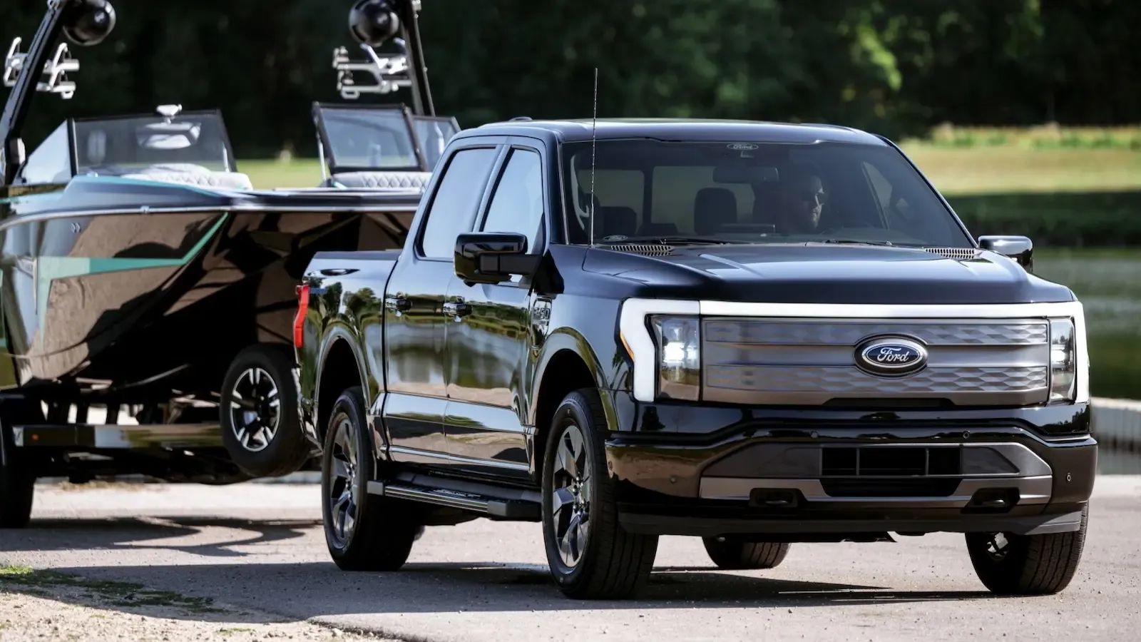 black Ford f-150 towing on the road 