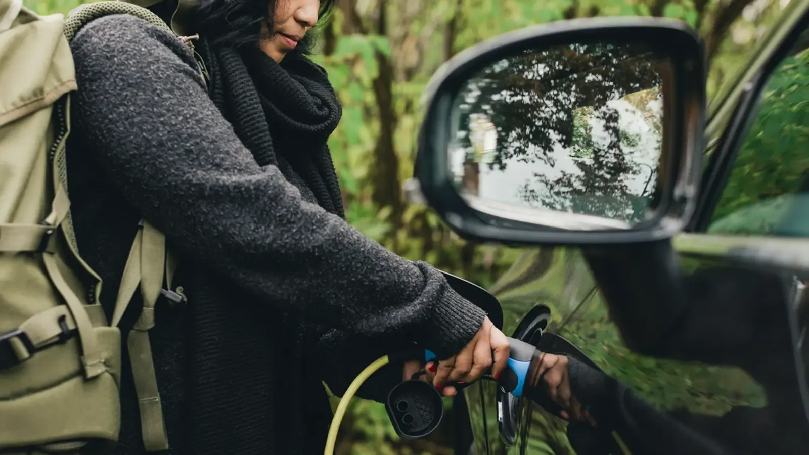 Hiker charging car outdoors 