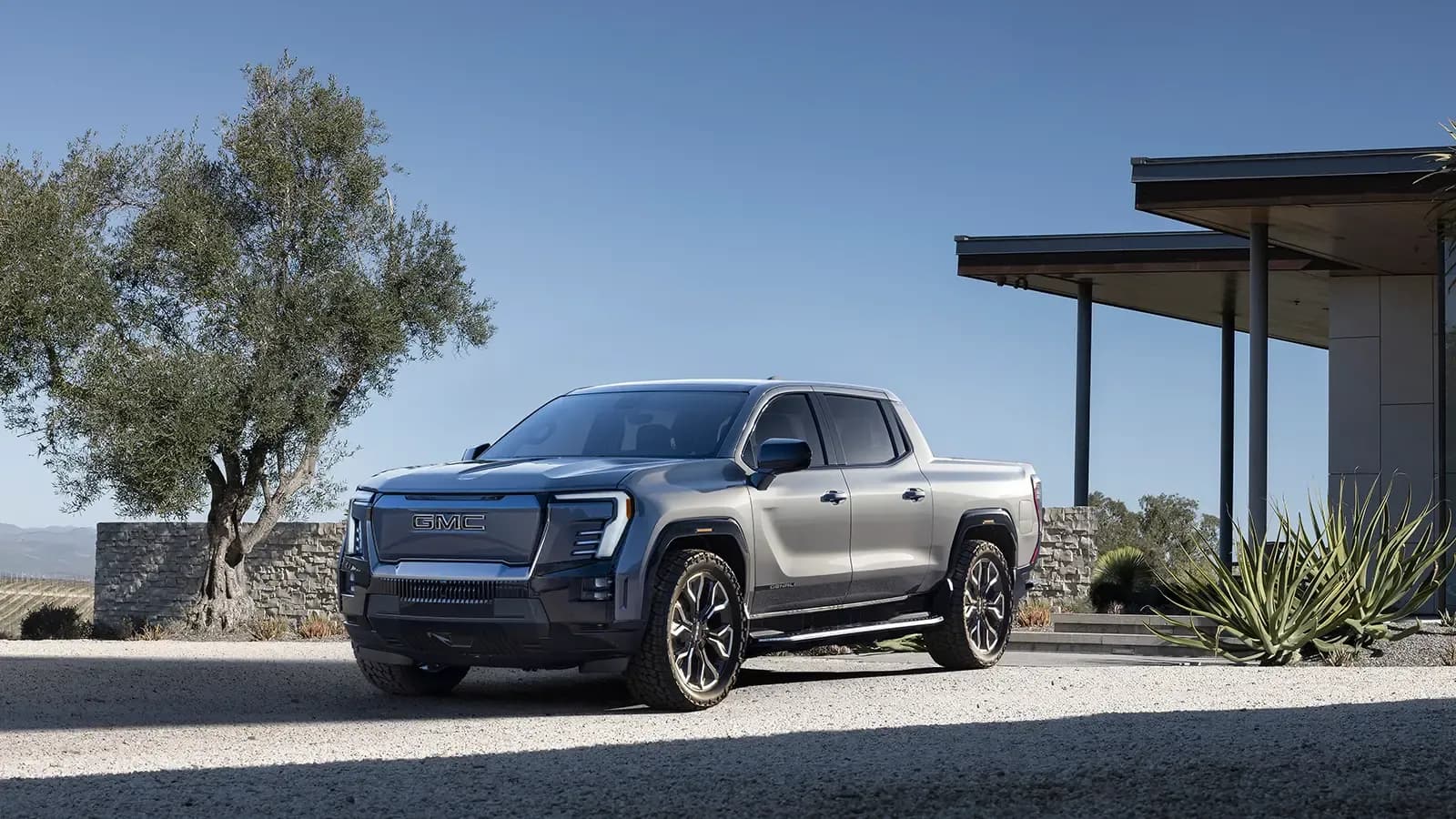 GMC Sierra EV Denali exterior view parked outside a home 
