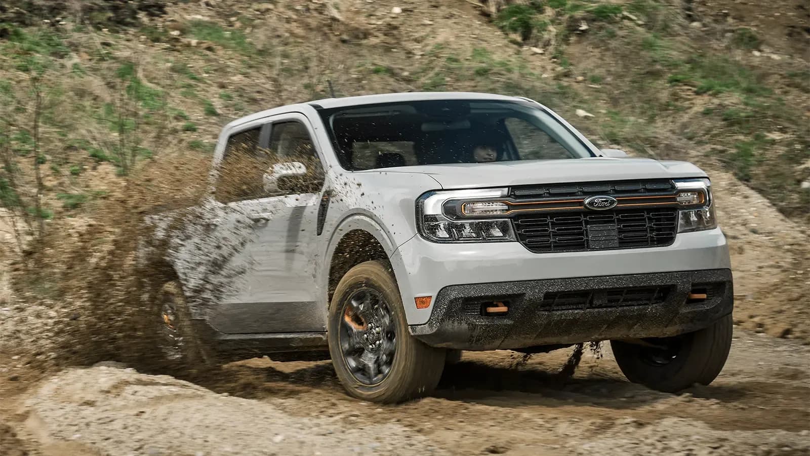 Ford Maverick Tremor driving through mud and dirt