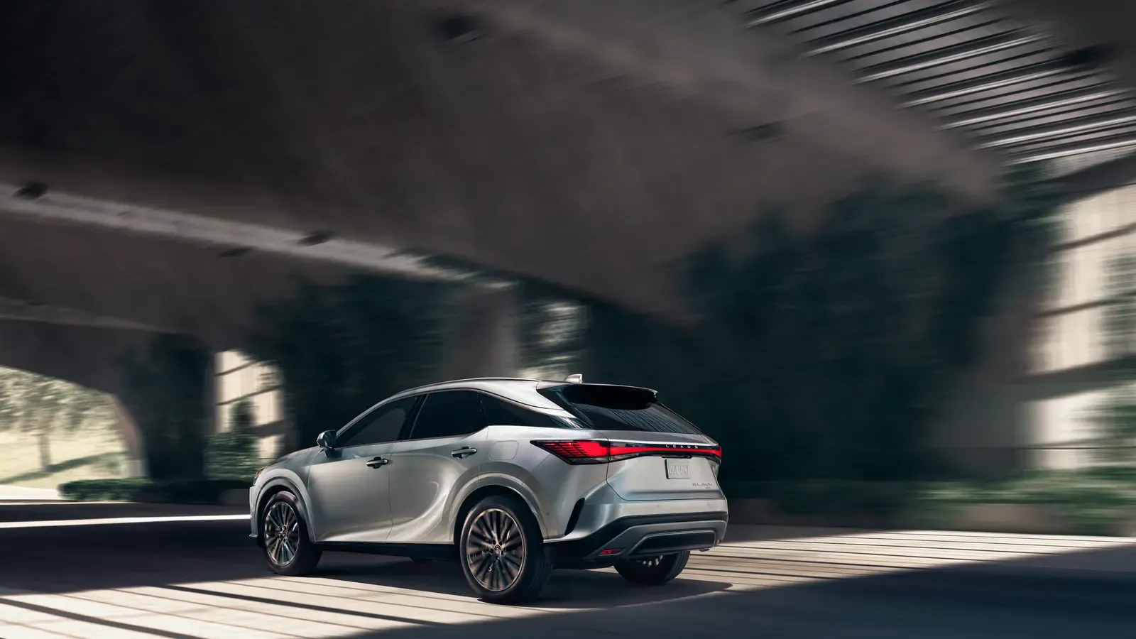 RX450h+ Luxury 3/4 exterior view driving