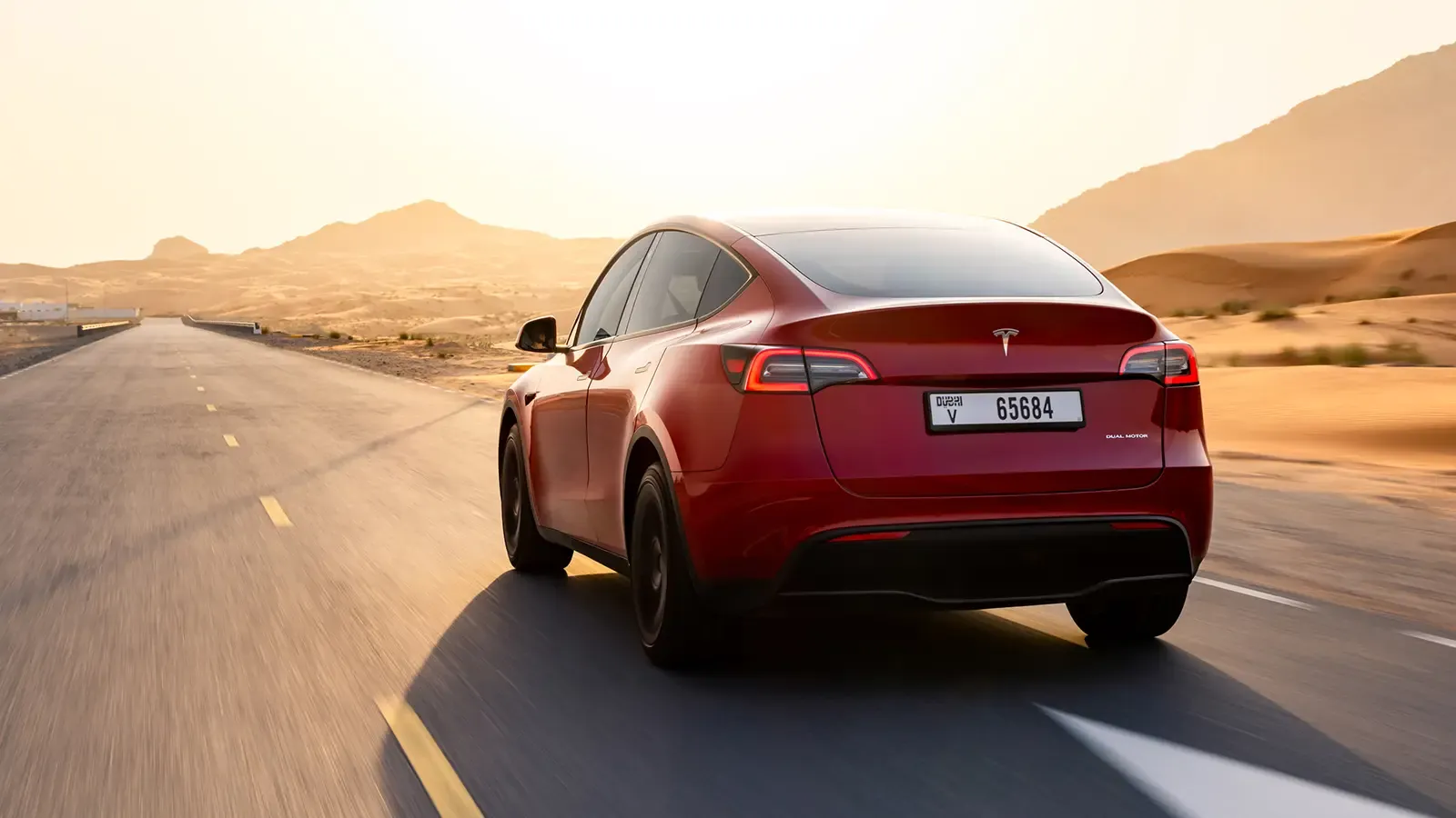 Back view of Tesla Model Y driving on the road 