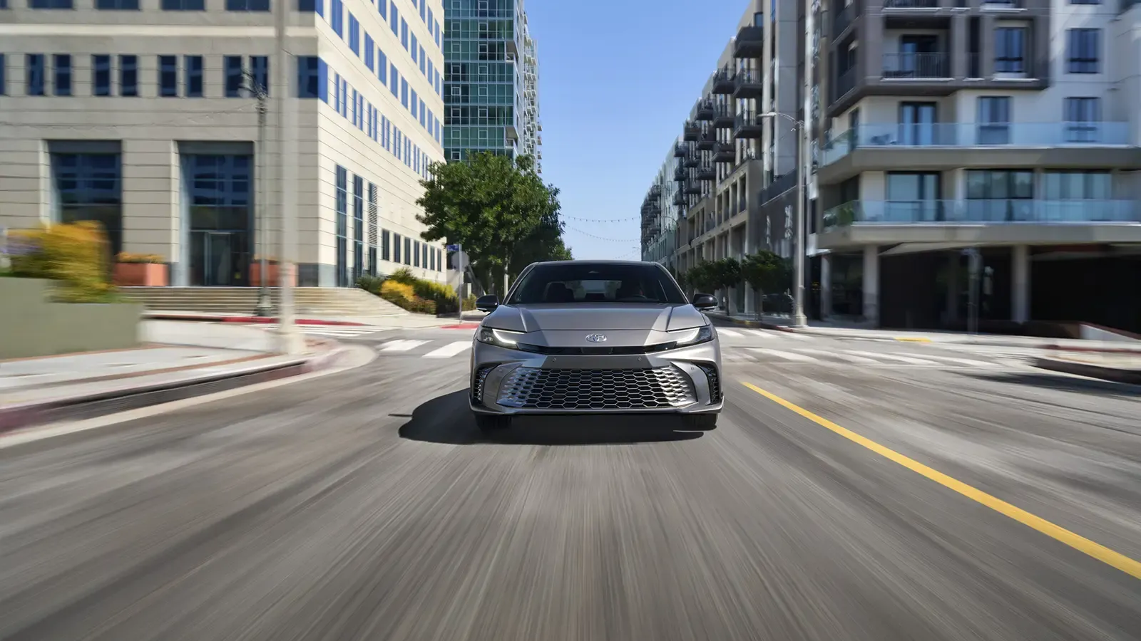 2025 Toyota Camry Hybrid driving on the road 