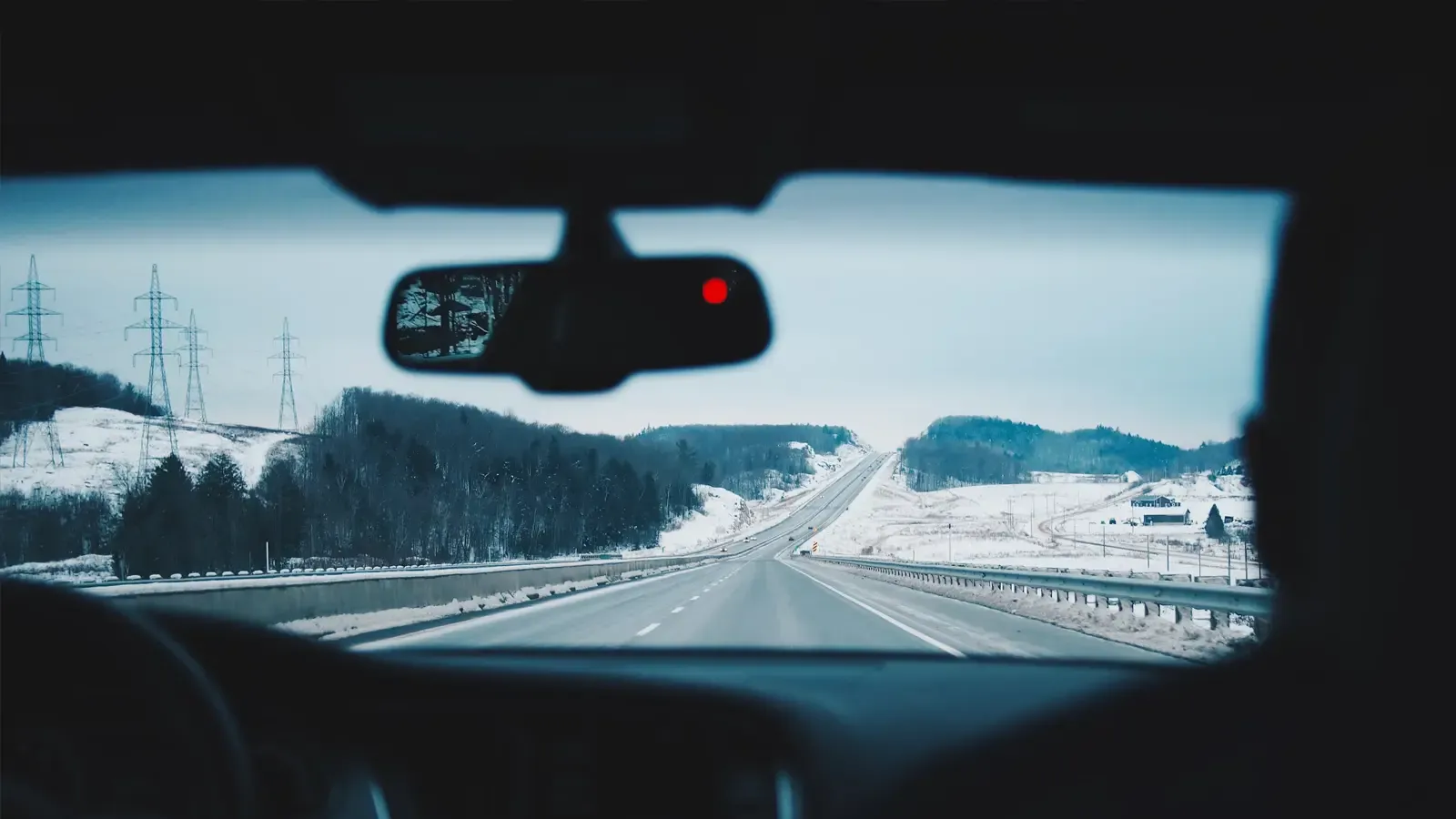 Interior car view of people driving on a snowy road