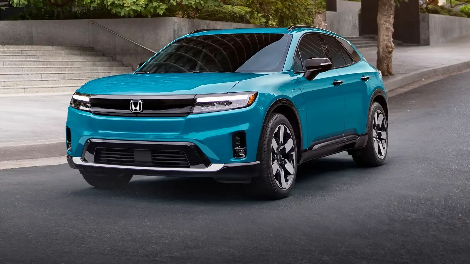 exterior view of a Honda Prologue driving on a road