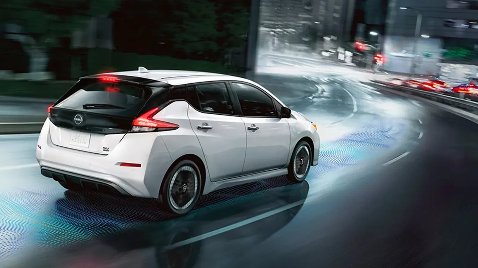 Nissan Leaf driving on a damp road