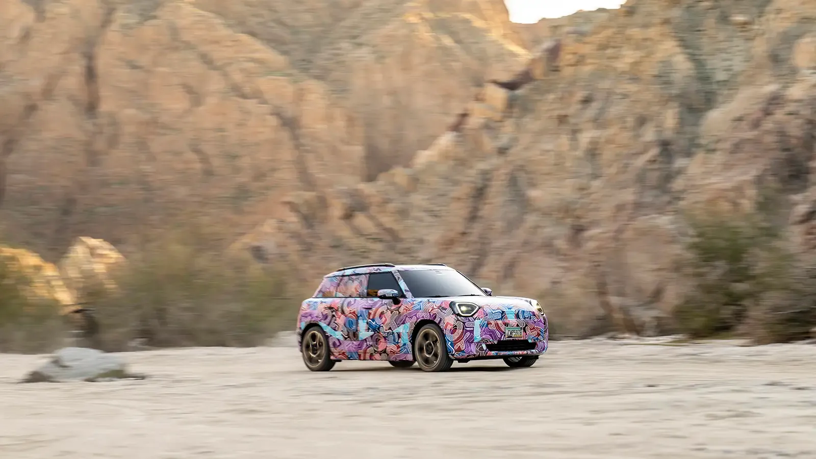 Mini Aceman EV driving on a mountainous road 