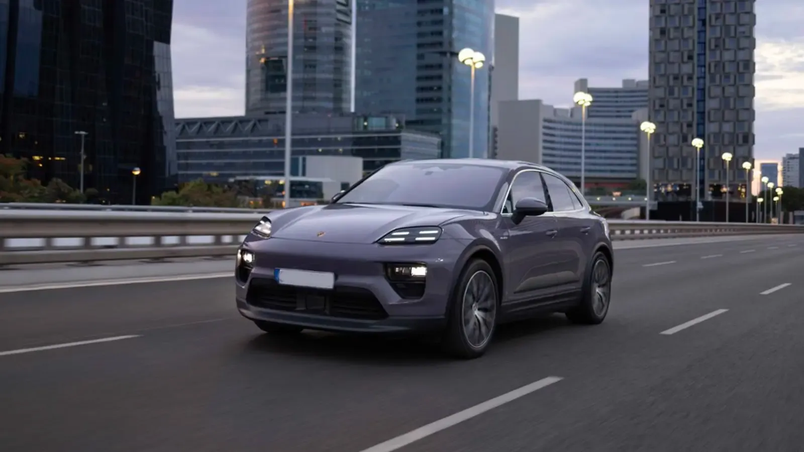 Porsche Macan EV driving on a road