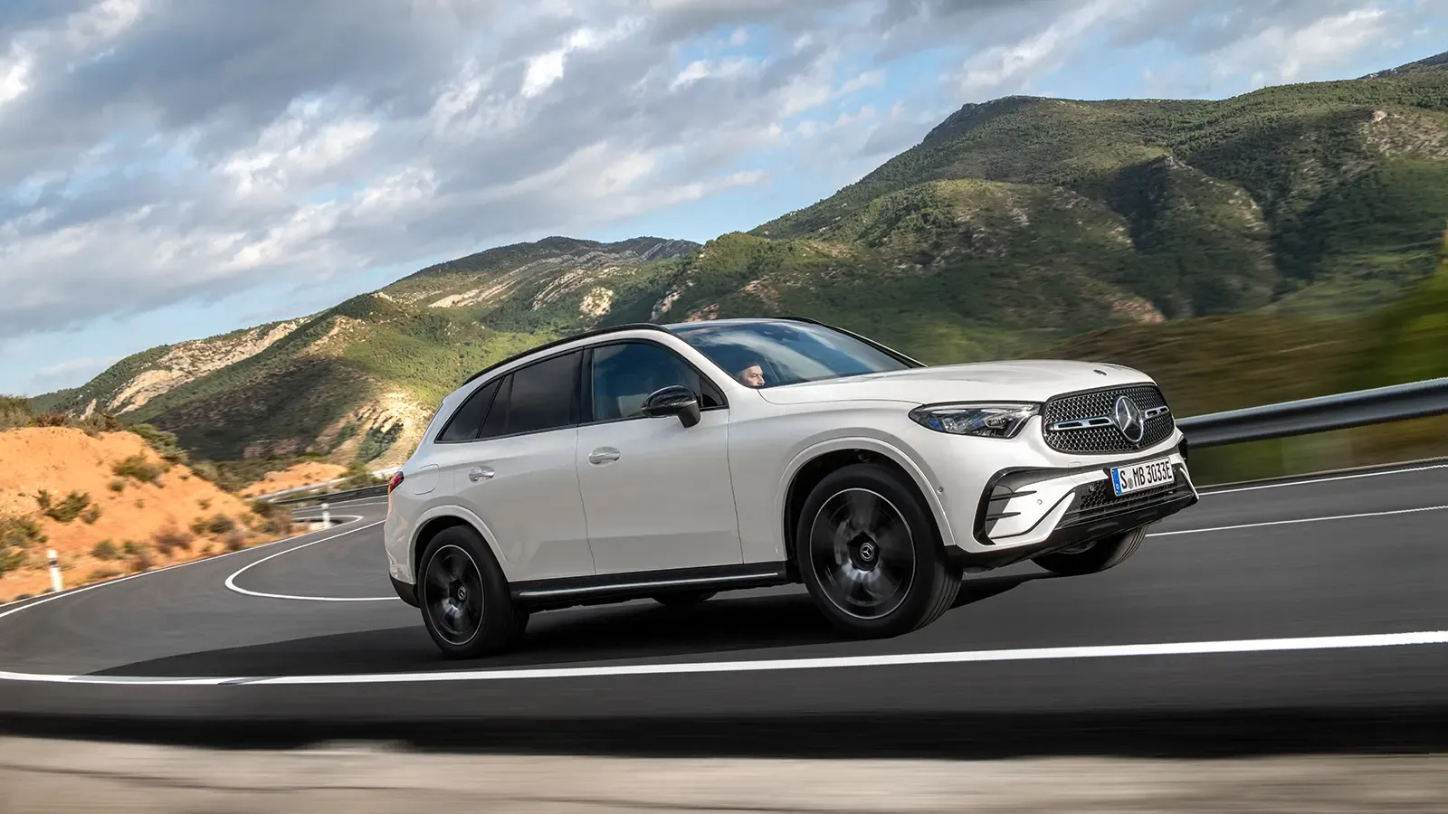 Plug-In Hybrid Mercedes SUV driving in the mountains 