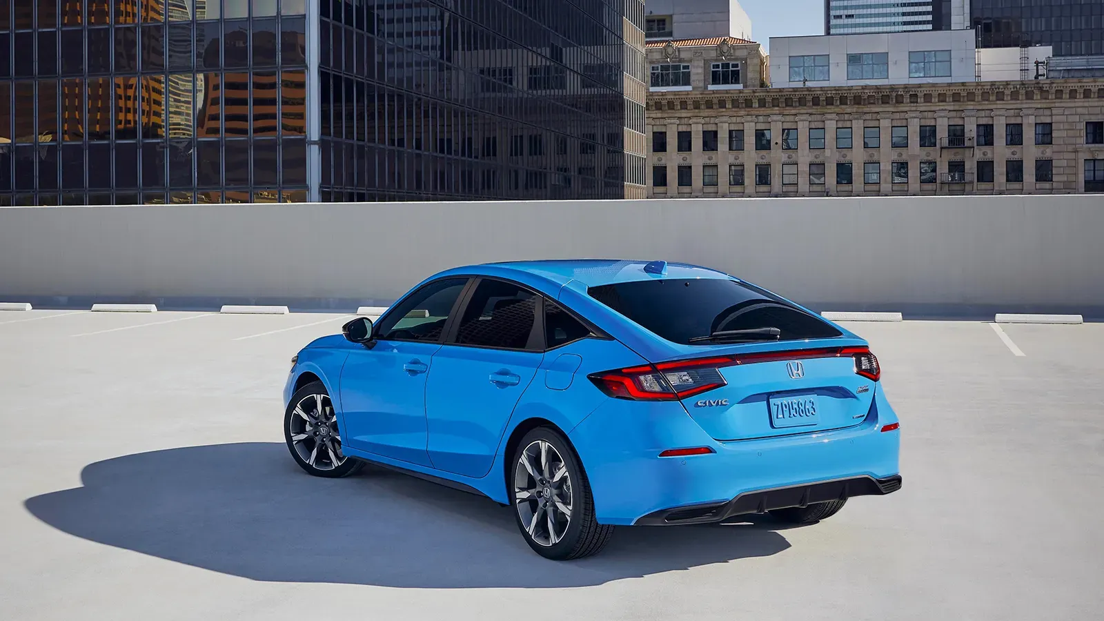 Blue Honda Civic Hybrid parked on top of building 