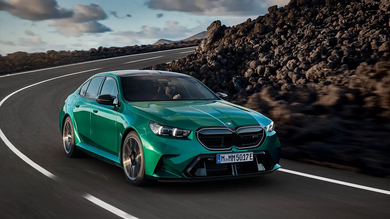 BMW M5 plug-in hybrid driving down a mountain