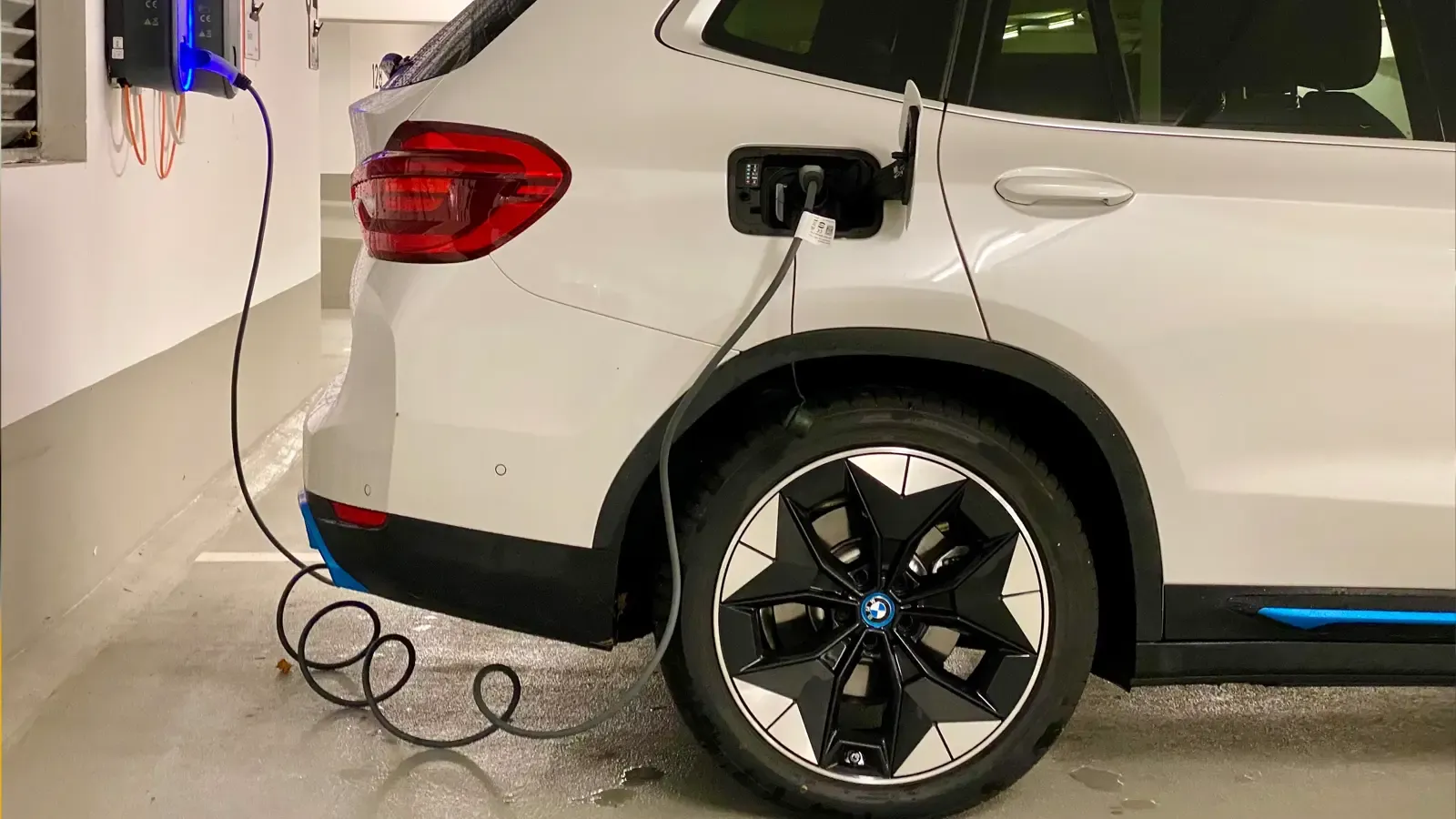 Car being charged in a car parking lot