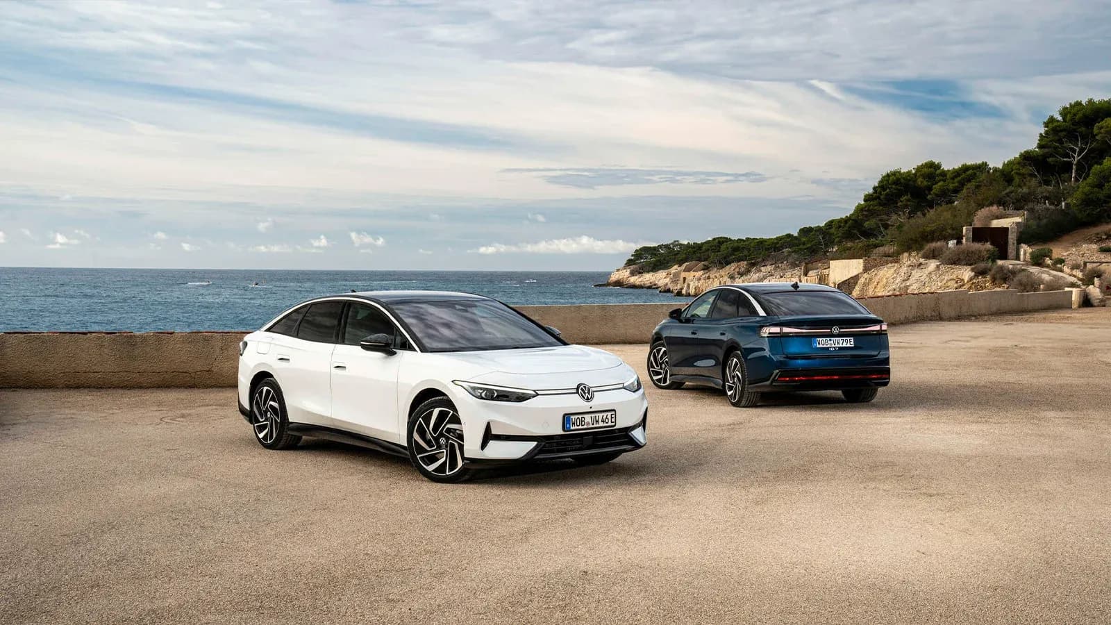 Volkwagen ID.7 EV Sedans parked along the water