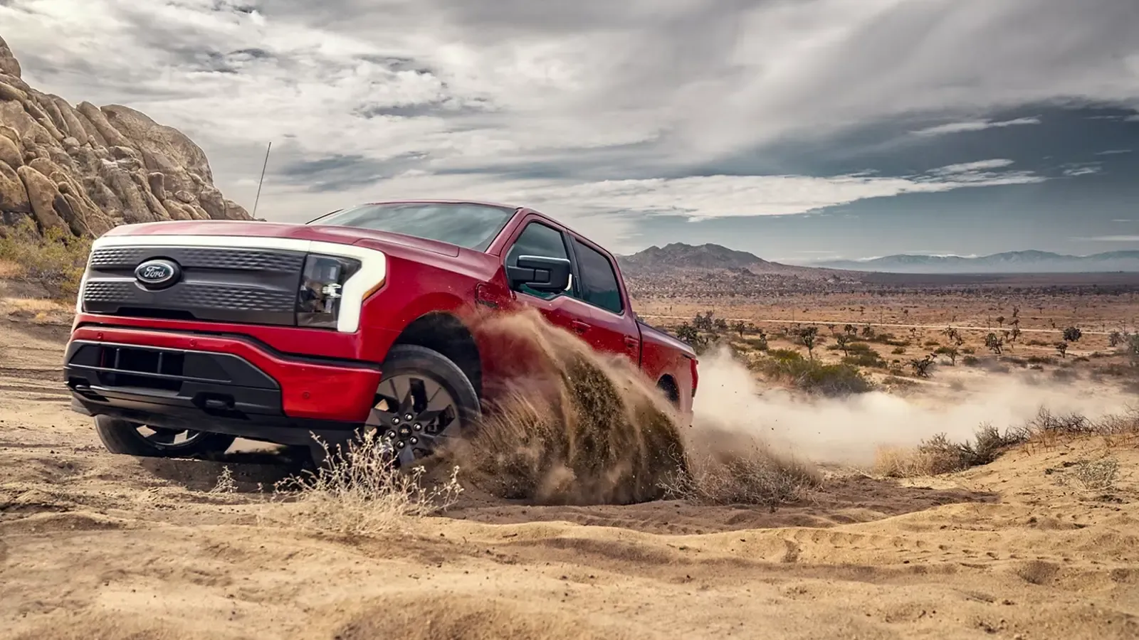 Ford F-150 Lightning driving on a dirt path 