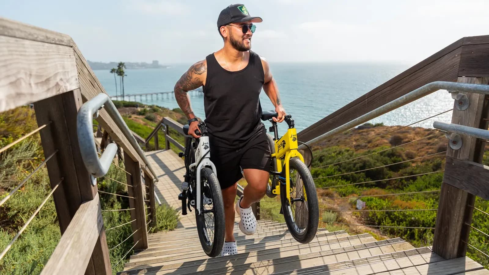 man carrying 2 e-bikes