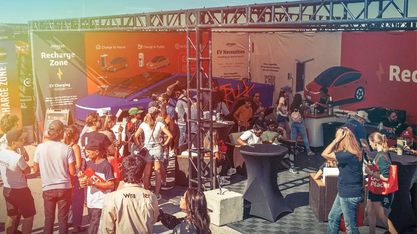 A crowd of people outside a booth with a Cybertruck at Electrify Expo