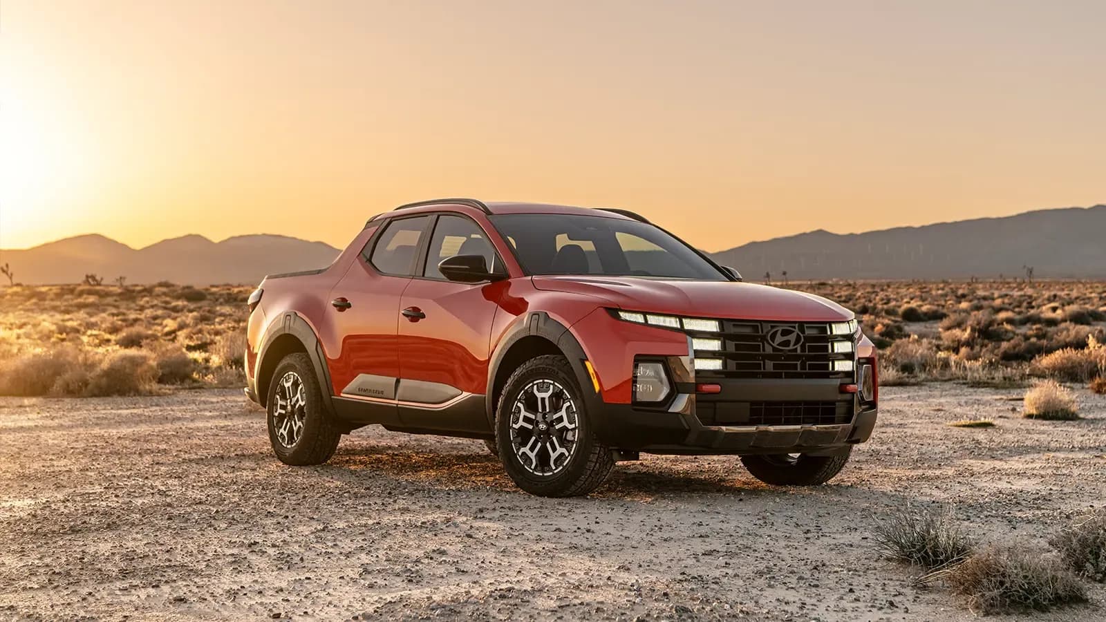 A red 2025 Hyundai santa cruz in the desert