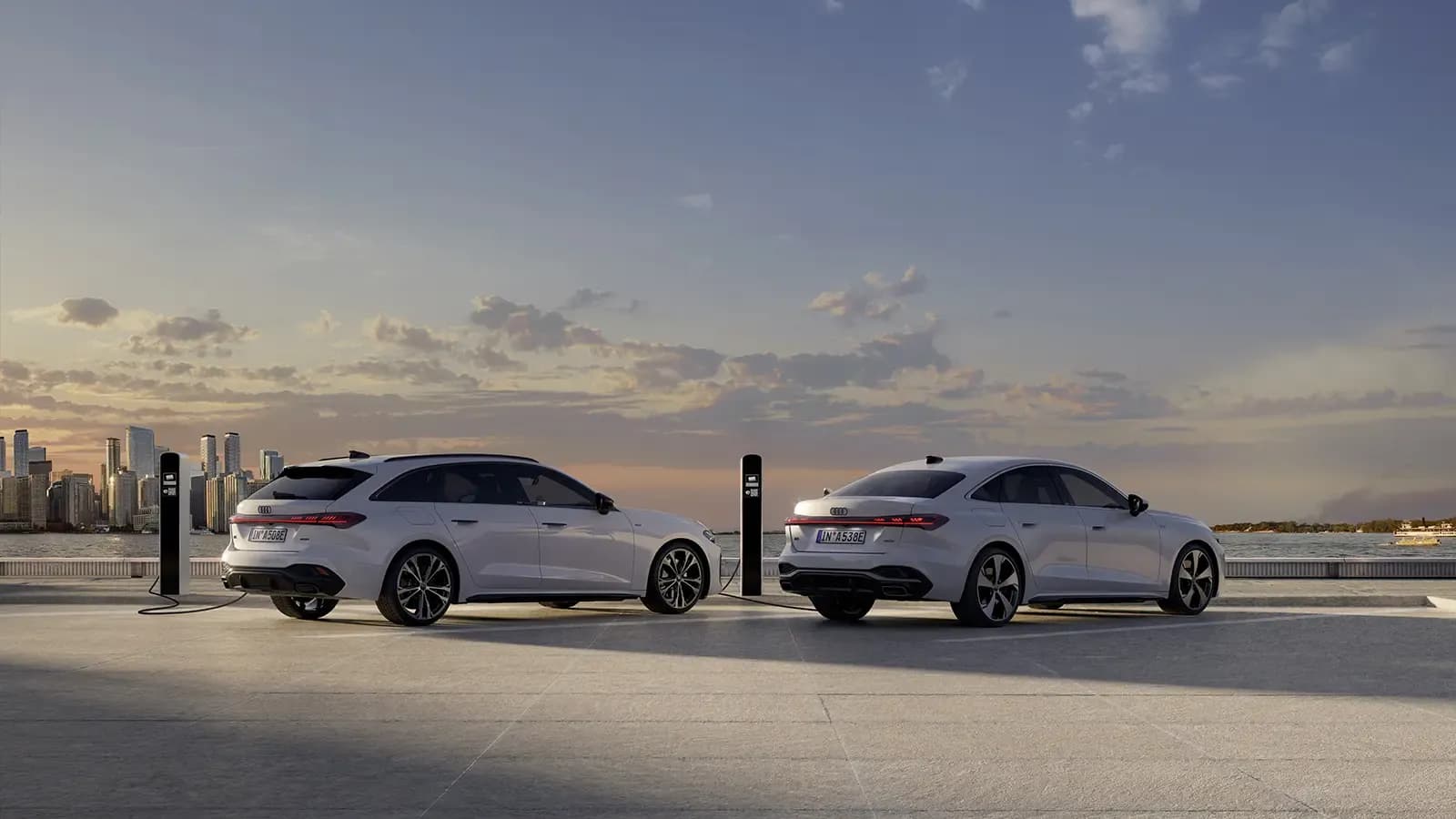 two Audi A5 Plug In Hybrids wagon and sedan parked
