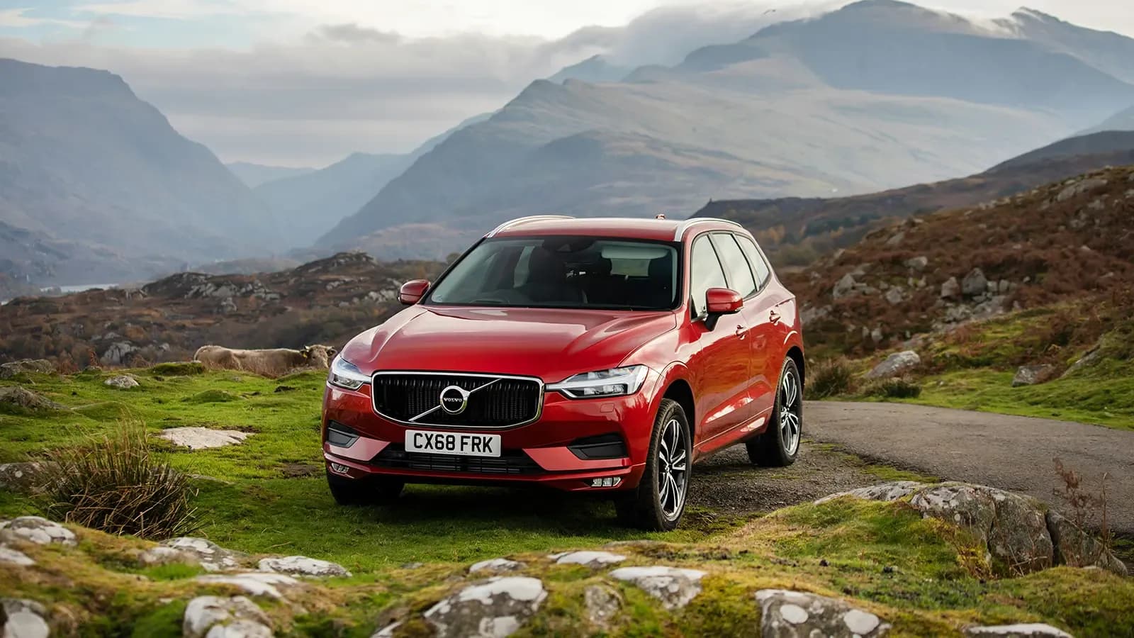 A red Volvo on a mountaintop