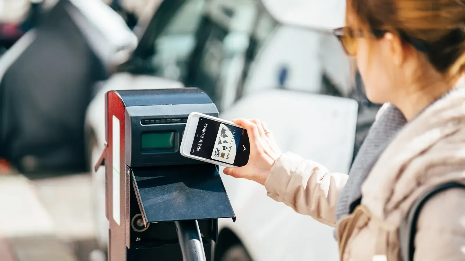 Lady scanning payment for EV charging