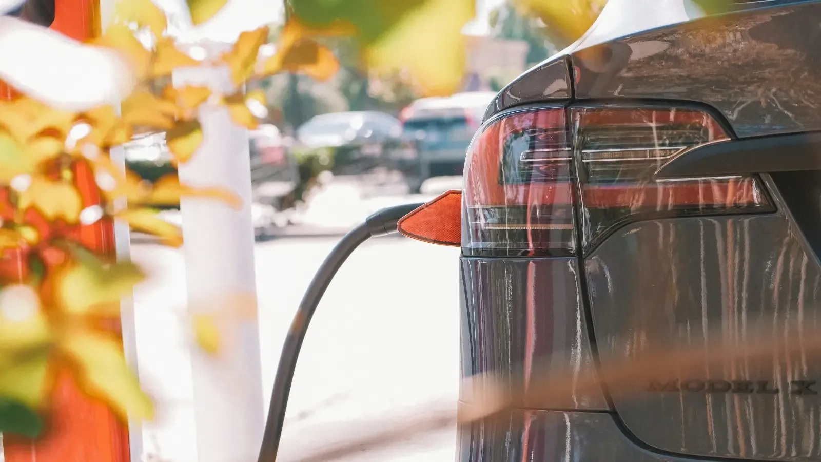 electric vehicle parked and plugged into a public EV charger