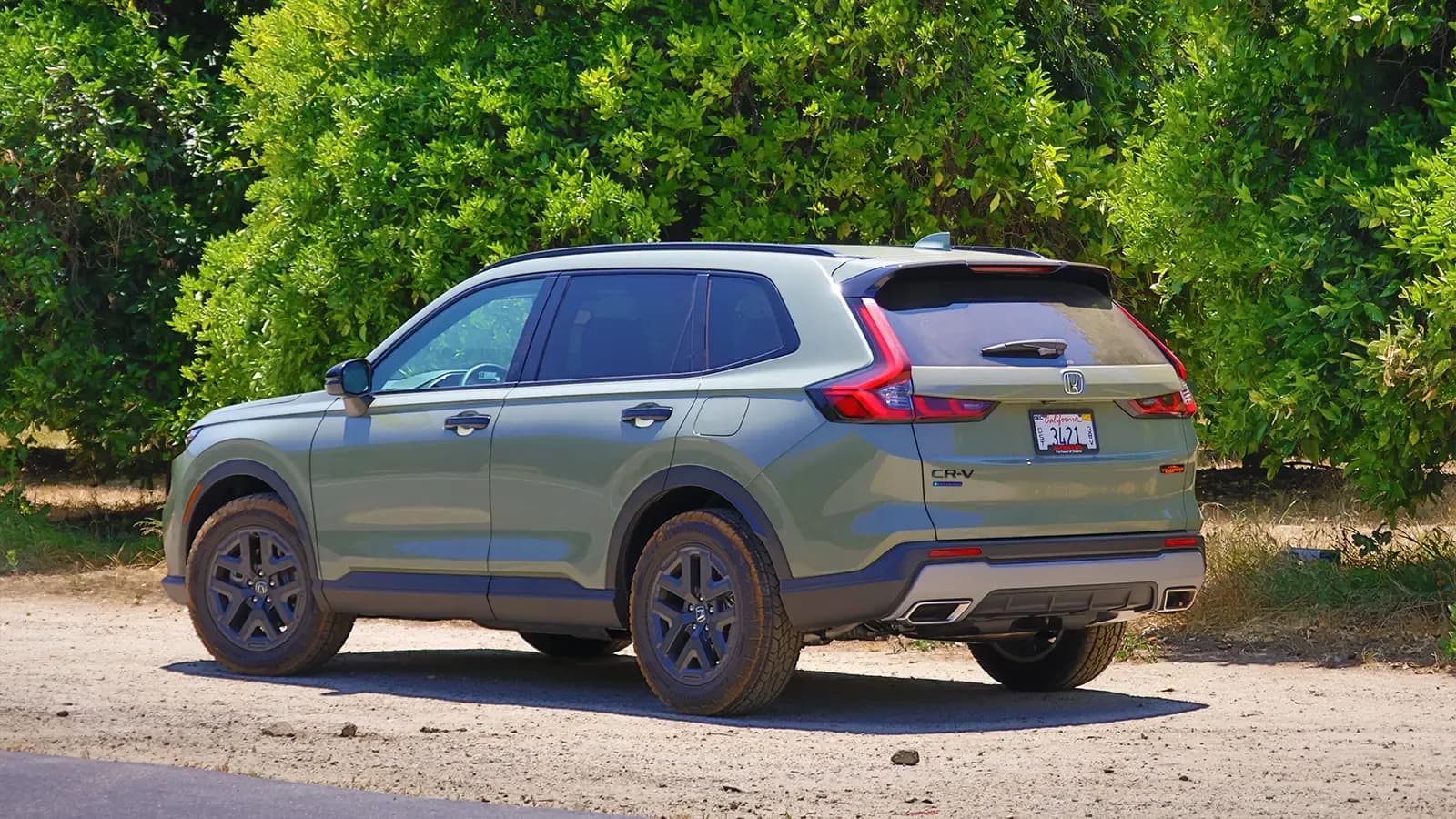 A dark green 2025 Honda CR-V hybrid three quarter rear view