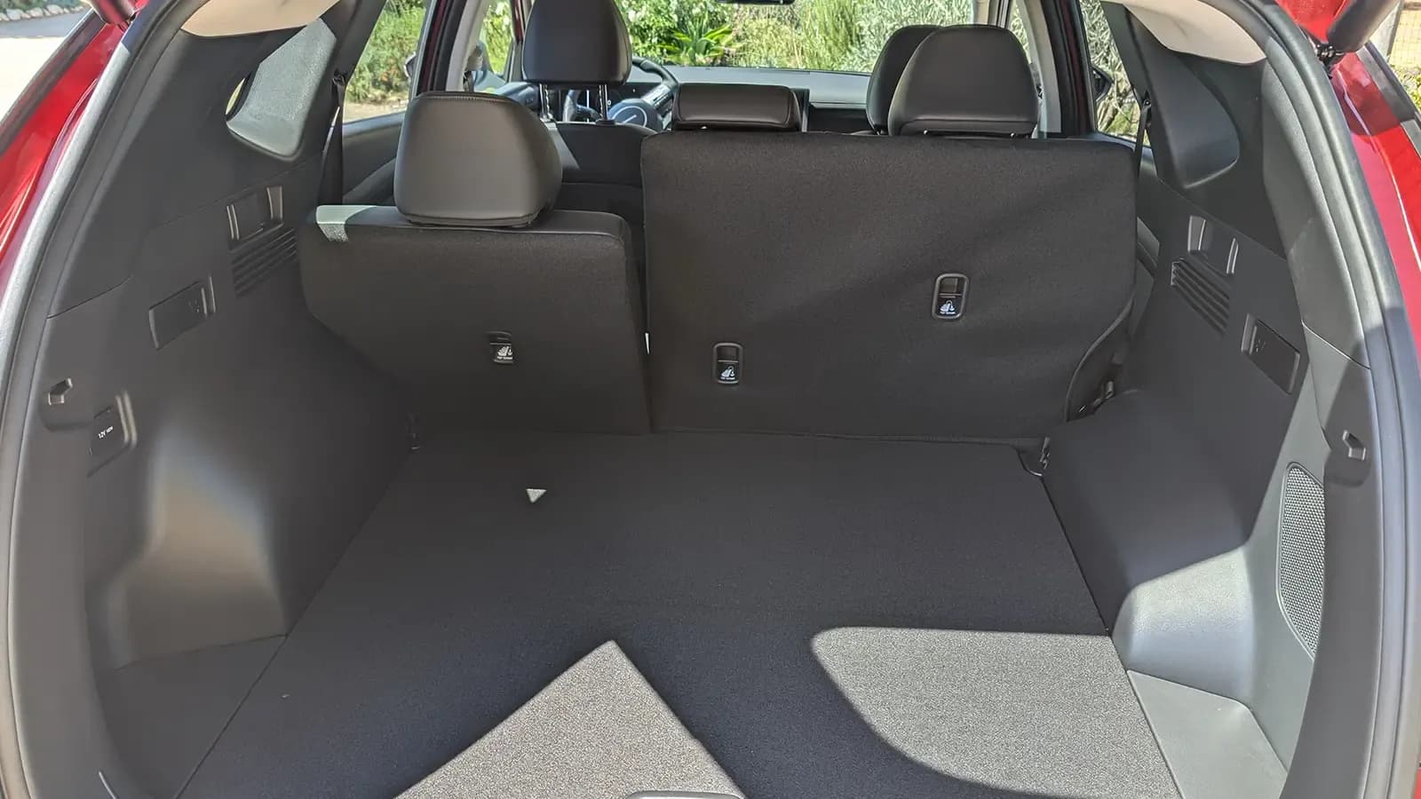 A light blue 2026 Hyundai Tucson Hybrid interior cargo trunk view
