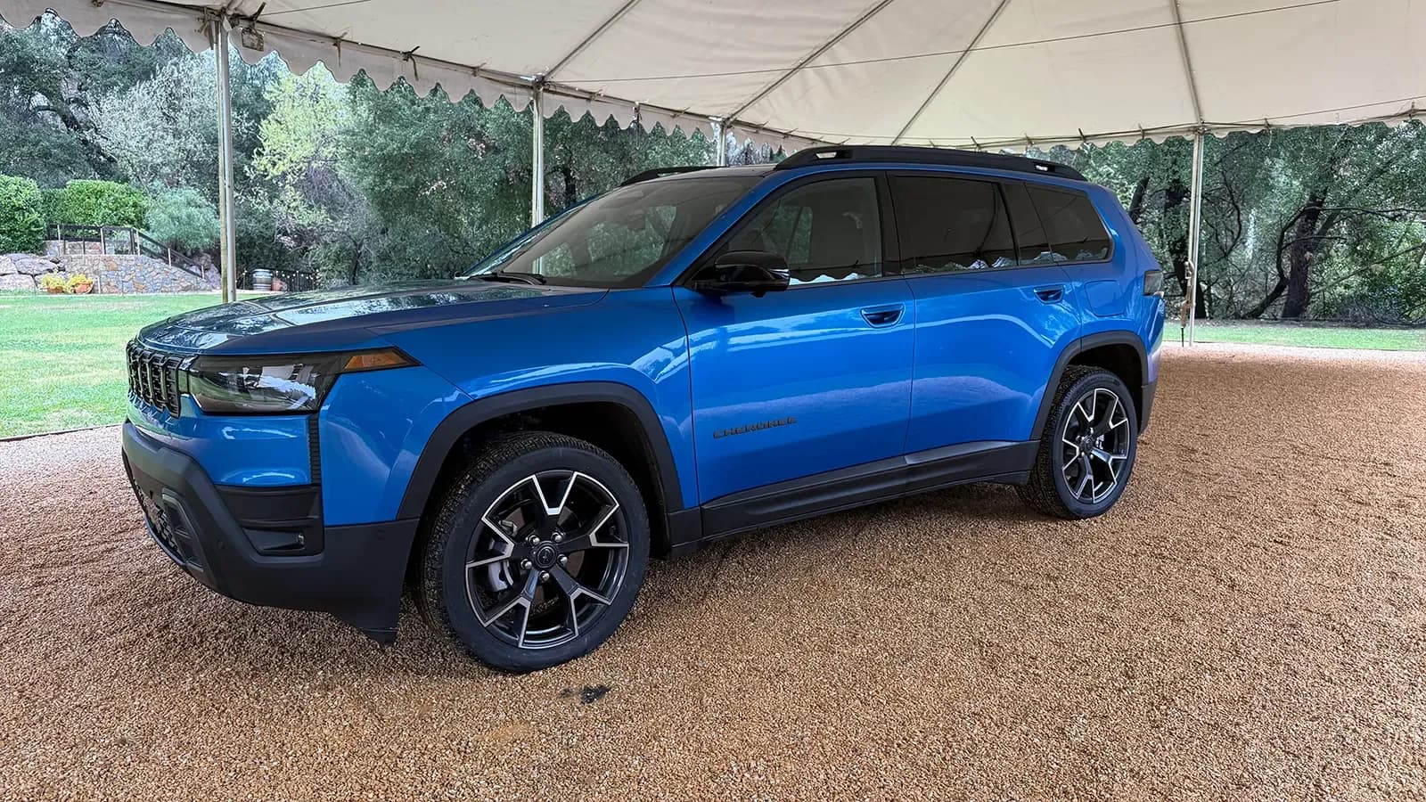 A blue 2026 Jeep Cherokee side three quarter view