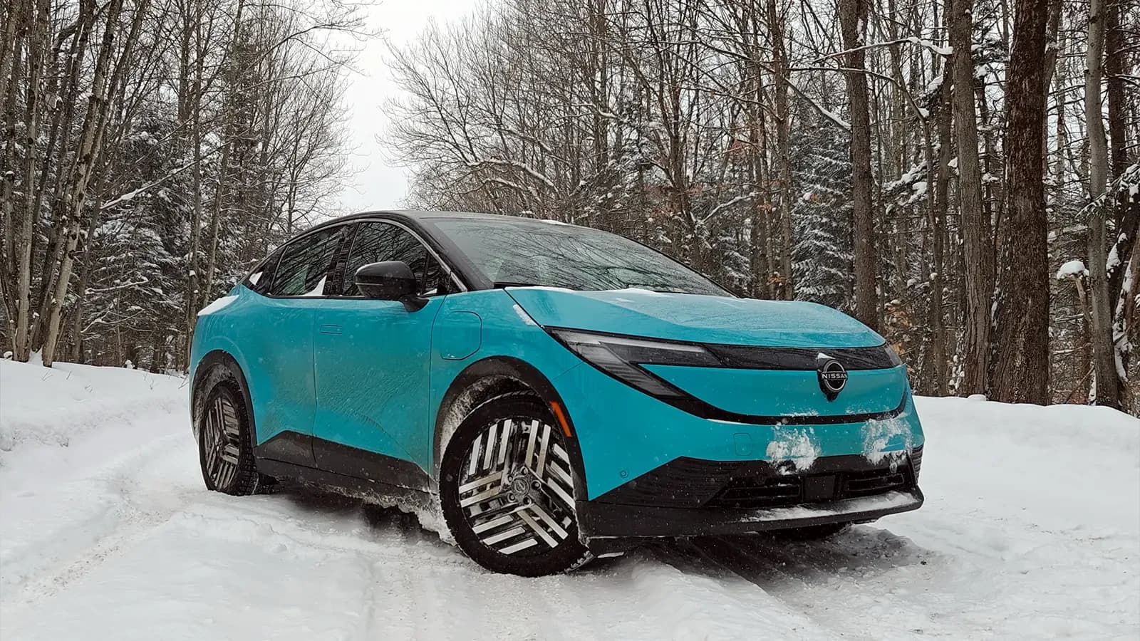 A teal 2026 Nissan Leaf in the winter three quarter front view