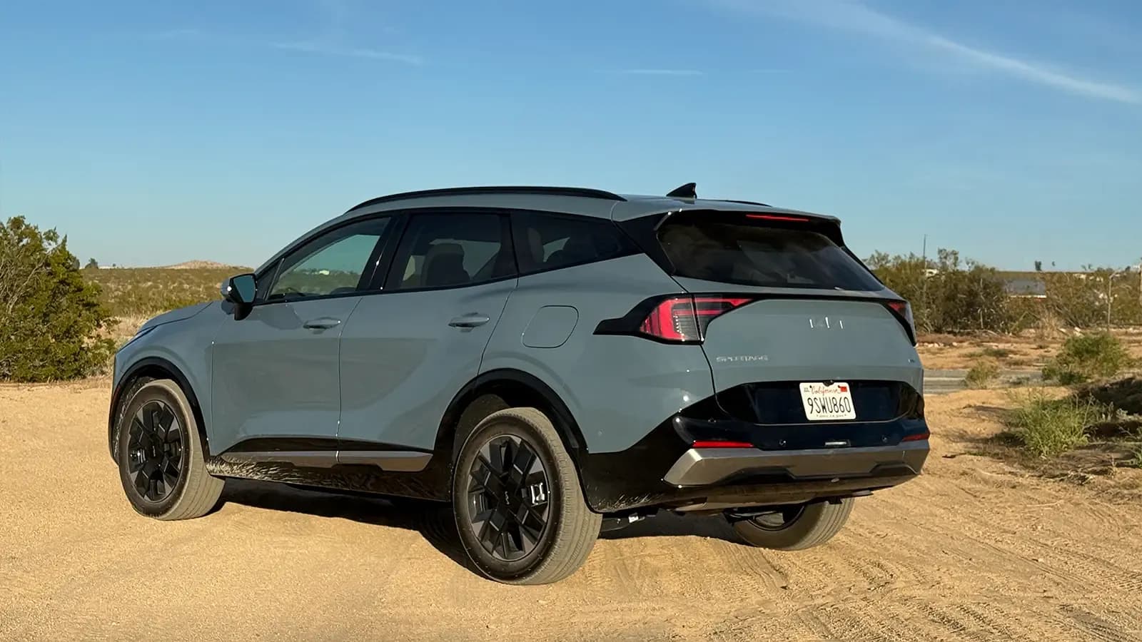A dark gray 2026 Kia Sportage three quarter rear view