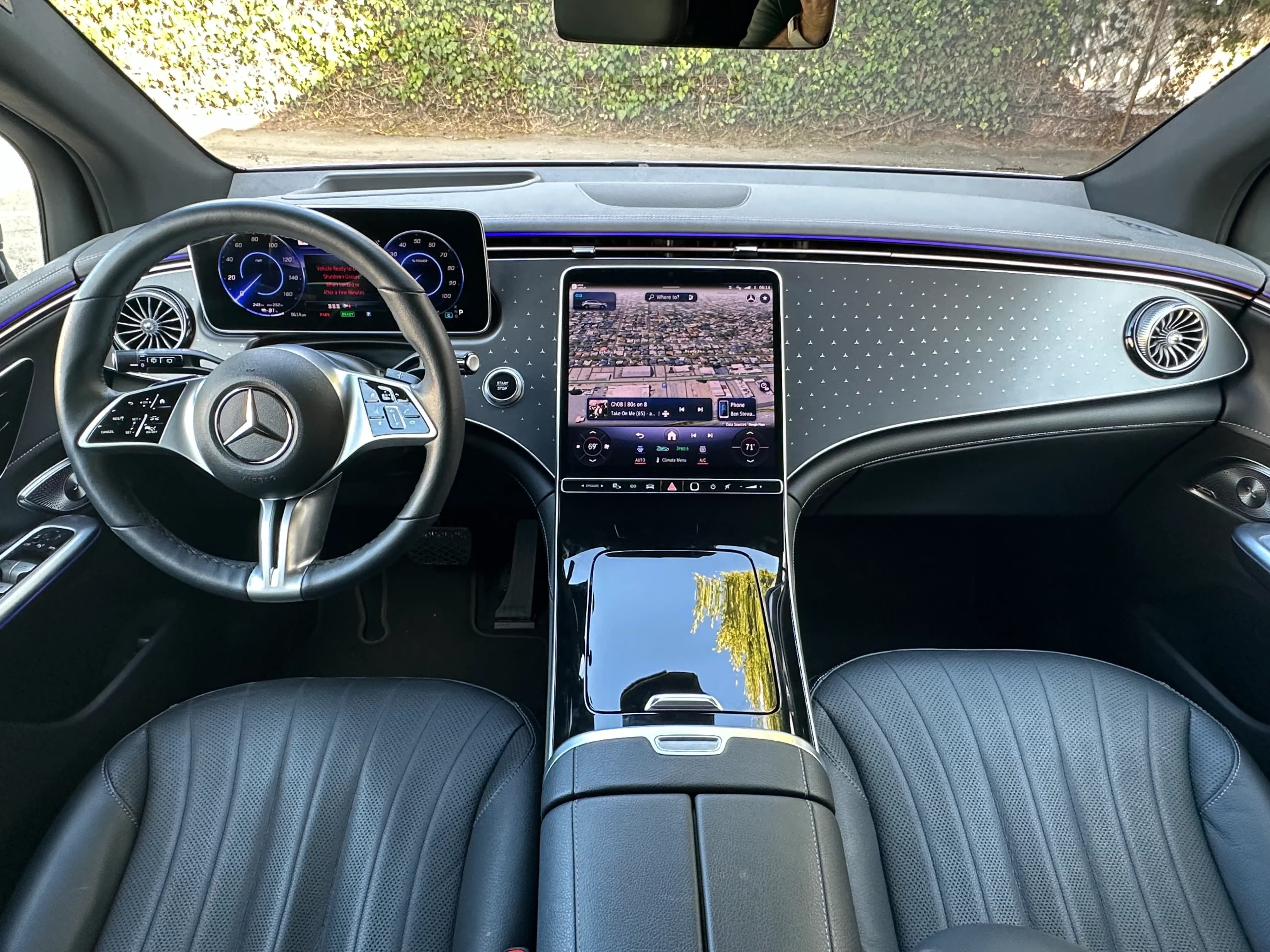 Mercedes-Benz EQE dashboard and front seats, with twin round vents and a large center console.