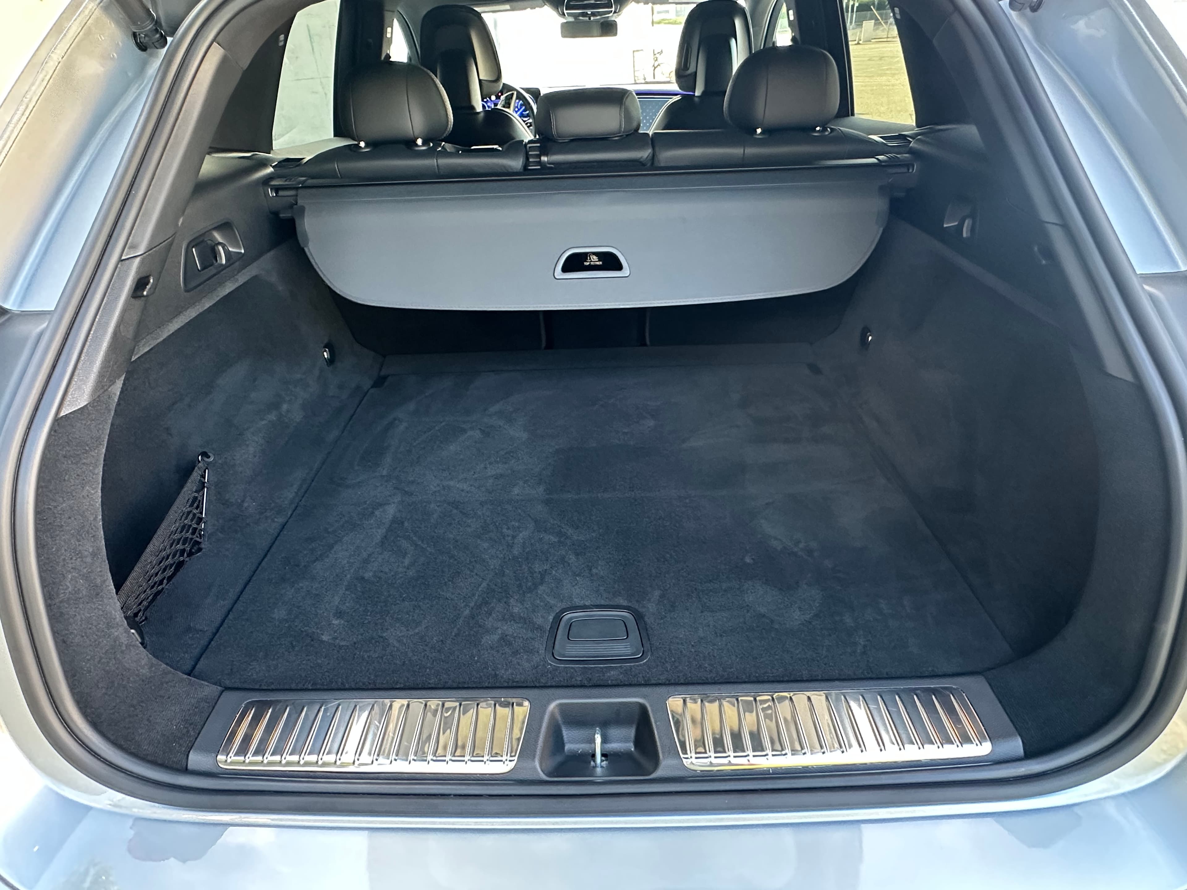 Rear cargo area of a Mercedes-Benz EQE SUV with the parcel shelf in place.