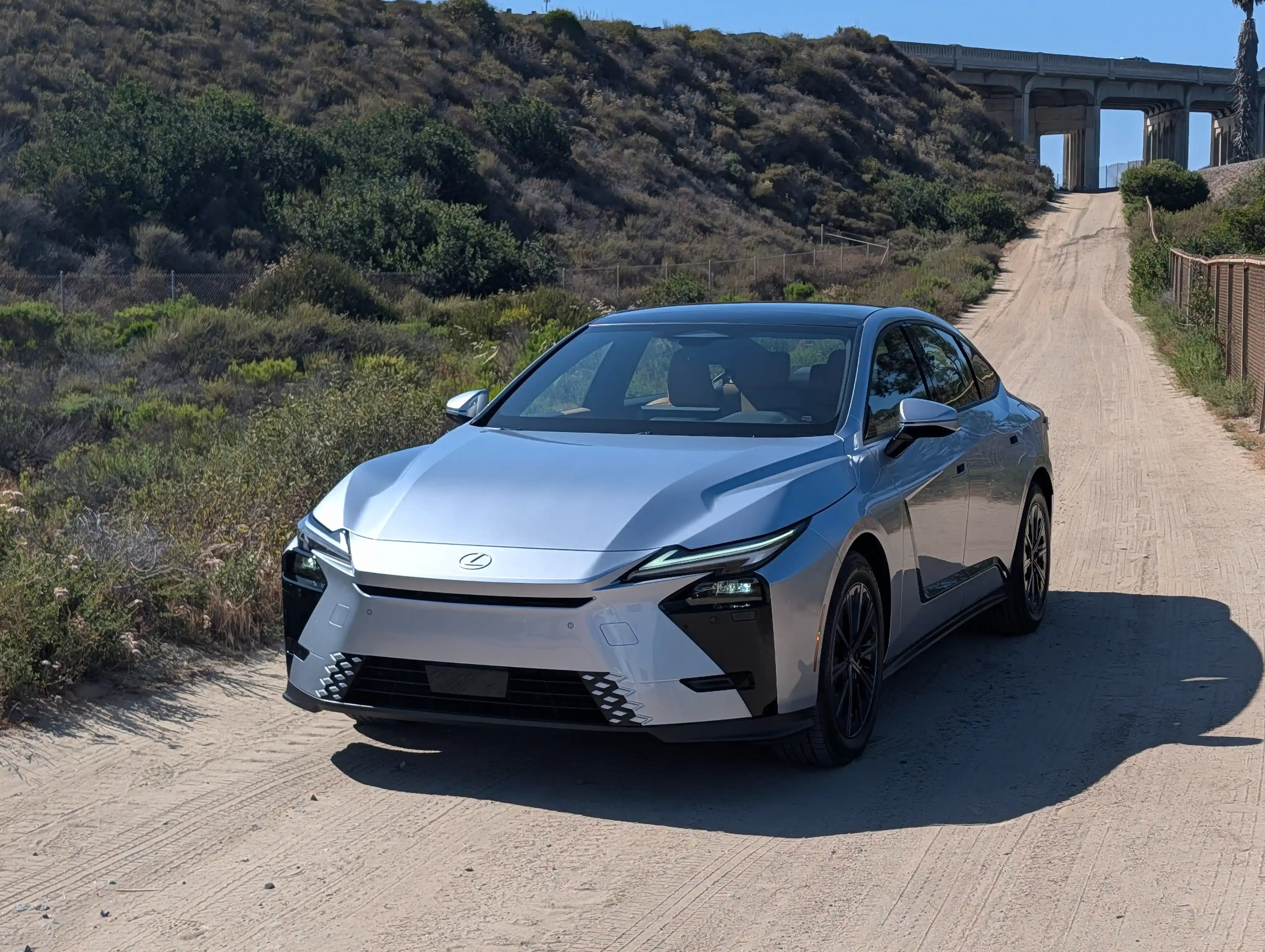 Front three-quarter view of a silver Lexus ES sedan on a dirt road.